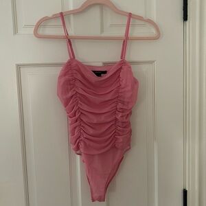 Pink ruffled body suit